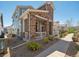 Exterior of a charming home featuring a stone facade, covered porch, and professionally landscaped front yard at 5723 S Union Ct, Littleton, CO 80127