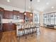 Spacious kitchen featuring a central island with seating, stainless steel appliances, and hardwood floors at 5723 S Union Ct, Littleton, CO 80127