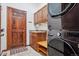Well-equipped laundry room with a washer and dryer, storage cabinets, sink, and wooden door at 5723 S Union Ct, Littleton, CO 80127