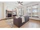 Inviting living room features a stone fireplace, large windows with natural light, and comfortable seating at 5723 S Union Ct, Littleton, CO 80127