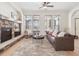 Cozy living room featuring a stone fireplace, large windows with natural light, and comfortable seating at 5723 S Union Ct, Littleton, CO 80127