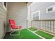 Small patio with artificial turf and red chair at 5723 S Union Ct, Littleton, CO 80127