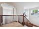 Upstairs hallway with a wooden railing and views to the lower level at 5723 S Union Ct, Littleton, CO 80127