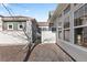 Enclosed backyard and gate view of a modern home with gravel landscaping and architectural windows at 9796 W Hinsdale Pl # 4, Littleton, CO 80128