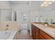 Well-appointed bathroom with double sinks, soaking tub, and separate shower, providing a spa-like experience at 9796 W Hinsdale Pl # 4, Littleton, CO 80128