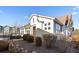 A charming home exterior featuring neutral stucco, a brown roof, and attractive landscaping at 9796 W Hinsdale Pl # 4, Littleton, CO 80128