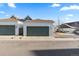 A two-car garage featuring paneled doors for a townhome in a residential neighborhood at 9796 W Hinsdale Pl # 4, Littleton, CO 80128