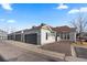 Street view of modern townhomes with attached garages and well-maintained exteriors in a residential area at 9796 W Hinsdale Pl # 4, Littleton, CO 80128