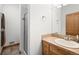 Bright bathroom with a walk-in shower, a tile vanity with storage, and stylish fixtures at 27711 Moffat Rd, Evergreen, CO 80439