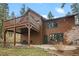 Beautiful exterior of a home with a spacious deck and outdoor seating area at 27711 Moffat Rd, Evergreen, CO 80439