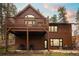 Stunning home exterior with a second-story deck overlooking the landscaped yard at 27711 Moffat Rd, Evergreen, CO 80439