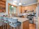A kitchen with granite counters, stainless appliances, and bar seating overlooking a tree-filled lot at 27711 Moffat Rd, Evergreen, CO 80439