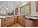 An eat-in kitchen is naturally lit with a beautiful forest view and stainless steel appliances at 27711 Moffat Rd, Evergreen, CO 80439