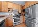 A light-filled kitchen boasts stainless steel appliances and abundant wood cabinetry at 27711 Moffat Rd, Evergreen, CO 80439