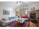 Inviting living room with stone fireplace, vaulted ceiling, and large windows with wooded views at 27711 Moffat Rd, Evergreen, CO 80439