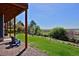 Enjoy this expansive backyard with lush lawn, mature trees, stone-lined creek bed, and comfortable seating area at 810 Trail Ridge Dr, Louisville, CO 80027