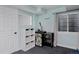 Finished basement area featuring a beverage refrigerator, storage, and natural light from a window at 810 Trail Ridge Dr, Louisville, CO 80027