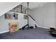 Finished basement area featuring workout equipment, medal display, and black metal support beam at 810 Trail Ridge Dr, Louisville, CO 80027