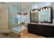 Bathroom featuring a soaking tub, glass shower, double vanity, and sleek fixtures at 810 Trail Ridge Dr, Louisville, CO 80027