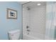 Clean bathroom with white subway tile in shower/bath and blue accent wall at 810 Trail Ridge Dr, Louisville, CO 80027