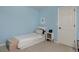 Bright bedroom featuring a white twin bed with storage, side table, and light blue walls at 810 Trail Ridge Dr, Louisville, CO 80027