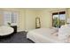 Bright bedroom featuring neutral walls, large windows, and comfortable seating at 810 Trail Ridge Dr, Louisville, CO 80027