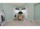 Cozy bedroom nook with wicker chair, side table, and bright natural light at 810 Trail Ridge Dr, Louisville, CO 80027