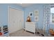 Light blue bedroom featuring a double door closet, dresser with stuffed animal, and elephant decor at 810 Trail Ridge Dr, Louisville, CO 80027