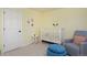 Bright Bedroom with a crib and chair at 810 Trail Ridge Dr, Louisville, CO 80027