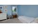 Charming bedroom with blue walls, playful decor, plush carpet, and a bright window view at 810 Trail Ridge Dr, Louisville, CO 80027