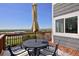 Outdoor deck with dining set and stunning views of the cityscape and mountains at 810 Trail Ridge Dr, Louisville, CO 80027
