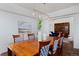 Cozy dining room with a wooden table, decorative chairs, and an elegant light fixture at 810 Trail Ridge Dr, Louisville, CO 80027