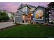 Charming two-story home with manicured lawn, stone accents, and a welcoming entrance. Two-car attached garage at 810 Trail Ridge Dr, Louisville, CO 80027