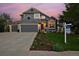 Charming two-story home featuring an attached two-car garage, manicured lawn, and professional landscaping at 810 Trail Ridge Dr, Louisville, CO 80027