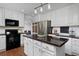 Bright kitchen with white cabinets, stainless steel appliances, and granite countertops at 810 Trail Ridge Dr, Louisville, CO 80027