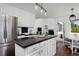 Bright kitchen featuring an island, stainless steel appliances, and access to an outdoor patio at 810 Trail Ridge Dr, Louisville, CO 80027