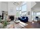 Bright living room with tall ceilings, a fireplace, and large windows at 810 Trail Ridge Dr, Louisville, CO 80027