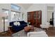 Spacious living room with hardwood floors, a cabinet, and abundant natural light at 810 Trail Ridge Dr, Louisville, CO 80027
