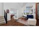 Comfortable living room with hardwood floors, large windows, and staircase access at 810 Trail Ridge Dr, Louisville, CO 80027