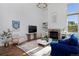 Bright living room with tall ceilings, a fireplace, and large windows at 810 Trail Ridge Dr, Louisville, CO 80027