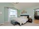 Spacious main bedroom featuring a large bed, bench, and ensuite bathroom at 810 Trail Ridge Dr, Louisville, CO 80027