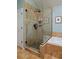 Shower featuring stone and tile with glass doors at 810 Trail Ridge Dr, Louisville, CO 80027
