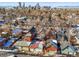 Aerial view of neighborhood with a Denver skyline background in the winter season at 2336 N High St, Denver, CO 80205
