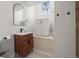Modern bathroom with a wood vanity, sleek fixtures, and a built-in tub at 2336 N High St, Denver, CO 80205