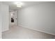 Carpeted bedroom with a ceiling light fixture and open door to bonus living area at 2336 N High St, Denver, CO 80205