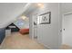 Cozy bedroom with sloped ceilings, skylights, and connected ensuite bathroom entrance at 2336 N High St, Denver, CO 80205