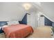 Bedroom with a sloped ceiling, a skylight, and a connecting hall with multiple entries at 2336 N High St, Denver, CO 80205