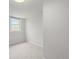 Bright bedroom with a window, neutral carpet, and white walls at 2336 N High St, Denver, CO 80205