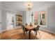 Dining area with hardwood floors, a modern light fixture and a lovely square wood table with seating at 2336 N High St, Denver, CO 80205