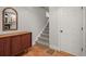 Hallway with hardwood floors, a decorative mirror, and stairs leading to the upper level at 2336 N High St, Denver, CO 80205